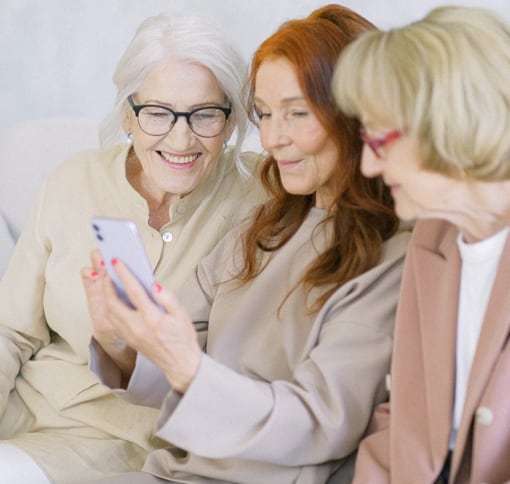 three women videochatting on a cell phone